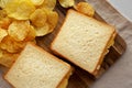 Homemade Egg Salad Sandwich with Potato Chips on a wooden board, top view Royalty Free Stock Photo