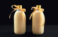 Homemade eggnog in bottles on dark background