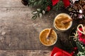 Homemade eggnog with cinnamon in glass on wooden table. Typical Christmas dessert.