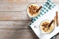 Homemade eggnog with cinnamon on wooden table. Typical Christmas dessert.