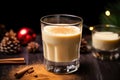 homemade eggnog in a glass by a pile of nutmeg