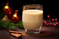 homemade eggnog in a glass by a pile of nutmeg