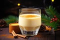 homemade eggnog in a glass by a pile of nutmeg