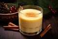 homemade eggnog in a glass by a pile of nutmeg