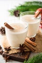 Homemade eggnog with grated nutmeg and cinnamon on white wooden table. Traditional Christmas drink. Royalty Free Stock Photo