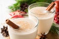 Homemade eggnog with grated nutmeg and cinnamon on white wooden table. Traditional Christmas drink. Royalty Free Stock Photo