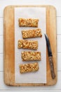 Homemade energy granola bars on wooden cutting board with knife.