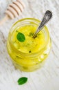 Homemade exfoliating honey scrub for face and body with sugar, honey, lemon, olive oil and mint. DIY cosmetics and spa recipe Royalty Free Stock Photo