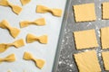 Homemade farfalle pasta on grey table