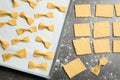 Homemade farfalle pasta on grey table