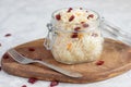 Homemade fermented sauerkraut with cranberries in a glass jar on a wooden stand and a fork next to it. Preparations, canning for Royalty Free Stock Photo