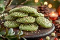 Homemade Festive Green Matcha Tea Cookies with White Sesame Seeds on a Rustic Wooden Board with Christmas Decorations