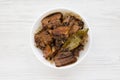 Homemade Filipino Adobo Pork on a white wooden background, top view. Flat lay, from above, overhead