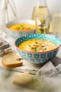 Homemade Finnish salmon soup with cream served with white wine. Selective focus