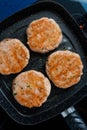 Homemade fish burgers in a pan