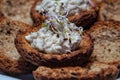 Homemade fish paste tarts with red onion sprouts on top