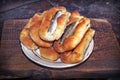 Homemade fish pies on a wooden textured surface against a background of stove brickwork