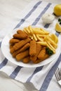 Homemade Fish Sticks and French Fries with Tartar Sauce on a white wooden background, low angle view Royalty Free Stock Photo