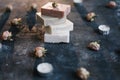 Homemade floral soap. Natural soap and flowers on dark background. Spa concept, natural cosmetics. Flat lay, top view