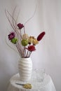 Homemade flower arrangement, handmade colorful flowers in white ceramic vase