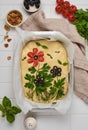 Homemade flower focaccia. Raw focaccia creatively decorated with vegetables on parchment paper. Sourdough dough