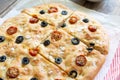 Homemade focaccia with black olives, cherry tomatoes, rosemary and salt Royalty Free Stock Photo