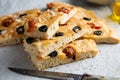Homemade focaccia with black olives, cherry tomatoes, rosemary and salt Royalty Free Stock Photo