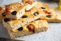 Homemade focaccia with black olives, cherry tomatoes, rosemary and salt Royalty Free Stock Photo