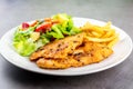 Homemade food concept. Chicken breast steak with black pepper served with salad and french fries in a white dish. High protein Royalty Free Stock Photo