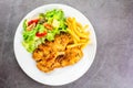 Homemade food concept. Chicken breast steak with black pepper served with salad and french fries in a white dish. High protein Royalty Free Stock Photo