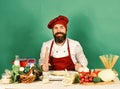 Homemade food concept. Man with beard sits by countertop Royalty Free Stock Photo