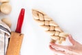 Homemade food concept process braiding bread braid challah dough on white background with copy space Royalty Free Stock Photo