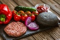 Homemade food. Front view of ingredients for beef black burger on black stone board. Delicious food Royalty Free Stock Photo