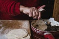 Making traditional Polish pierogi. Woman`s hand stuffing pierogi.