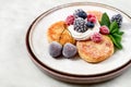 plate with cheese cakes and berries, mint, merble table