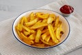 Homemade French Fries with Ketchup on a Plate, side view. Close-up Royalty Free Stock Photo