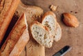 Homemade french two Baguette loafs and cut slice on wooden cutting board Royalty Free Stock Photo