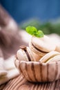 Homemade french vanilla coffee macaroon or macaron with mint leaf on wooden background