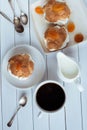 Homemade fresh cream puff with whipped cream and apricots, cup of coffee and milk jug. Toning. Royalty Free Stock Photo