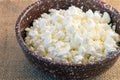 Homemade fresh crumbly delicious cottage cheese in a clay bowl. Royalty Free Stock Photo