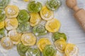 Homemade fresh Italian ravioli pasta on white wood table with flour, basil, tomatoes,background,top view Royalty Free Stock Photo