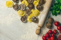 Homemade fresh Italian ravioli pasta on white wood table with flour, basil, tomatoes,background,top view Royalty Free Stock Photo