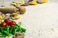 Homemade fresh Italian ravioli pasta on white wood table with flour, basil, tomatoes,background,top view Royalty Free Stock Photo