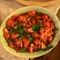 Homemade Fresh Juicy Tomato Salad with Arugula Leaves in Ceramic Bowl. Royalty Free Stock Photo