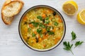 Homemade fresh lemon rice soup in a bowl on a white wooden surface, top view. Flat lay, overhead, from above. Copy space Royalty Free Stock Photo