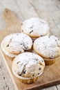 Homemade fresh muffins with sugar powder on cutting board rustic wooden table Royalty Free Stock Photo