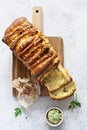 Homemade fresh pull apart bread with herbs parsley, thyme, rosemary, dill, garlic, cheese and spicy butter