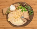 Homemade fresh ravioli with prosciutto,walnuts,brussels sprouts,artichoke and aromatic herbs paced on a rustic round centerpiece.