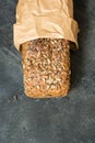 Homemade fresh rye bread with sunflower seeds on dark board. Close up. Copy space. Royalty Free Stock Photo