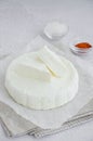 Homemade fresh soft cheese brynza or feta with chilli and sea salt on a light background. Vertical, copy space Royalty Free Stock Photo